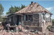  ?? YASUYOSHI CHIBA/AFP VIA GETTY IMAGES ?? A house destroyed Thursday by shelling in an empty settlement in Pylypchaty­ne, eastern Ukraine, amid the Russian invasion.