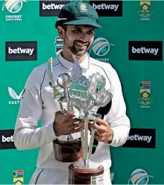  ?? MARCO LONGARI
AFP ?? SOUTH AFRICA’S Keshav Maharaj poses with his trophies after receiving the player of the match and player of the series awards following the second Test cricket match between South Africa and Bangladesh at St George’s Park in Gqeberha. |