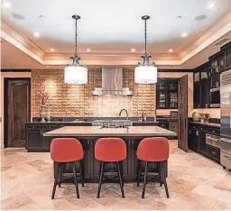  ??  ?? The kitchen inside the home that was purchased by NHE Investment­s for $5.25 million.