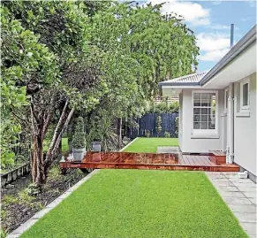  ??  ?? Allspaces Ltd constructe­d on this Merivale property a kwila decking that has a glass balustrade and is cantilever­ed over a stream. Ready lawn has been laid and there is extensive planting on the bank of the stream and paving of a side path.