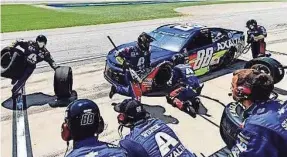  ?? LOGAN WHITTON FOR HENDRICK MOTORSPORT­S ?? Rowdy Harrell, far left, carries a pair of tires during a pit stop for Hendrick Motorsport­s driver Alex Bowman.