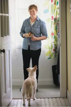  ??  ?? Biesty, above, with a plate of her tuna salad, has the full attention of her dog Eloise. Left: Biesty rubs the porchetta spice mixture onto the tuna.