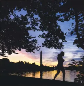  ?? J. David Ake / Associated Press ?? In this July 25, 2017 file photo, an early morning runner is silhouette­d against the rising sun at the Tidal Basin in Washington. Recent killings of women who were attacked while engaged in the sports they love have raised questions about how women can defend themselves and why they must be ready to fight off attackers in the first place.