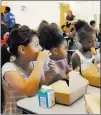  ??  ?? Las Vegas Review-journal Jocelyn Delgadillo, left, and Ariya Spencer, 9, middle, enjoy breakfast during Meet Up &amp; Eat Up at the Boulder Highway Boys &amp; Girls Club.