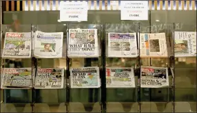  ?? (AP/Frank Augstein) ?? Newspapers covering Harry and Meghan’s television interview are displayed for sale Tuesday outside a shop in London.