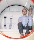  ??  ?? Josh Giegel, co-founder and CEO of Virgin Hyperloop, poses inside a prototype pod.