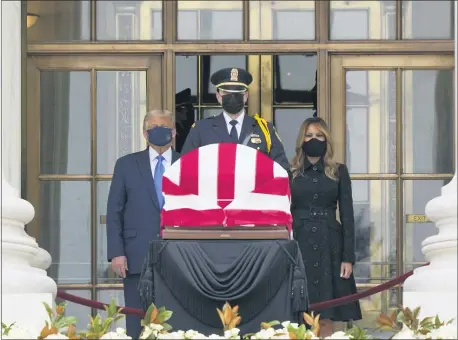  ?? J. SCOTT APPLEWHITE — THE ASSOCIATED PRESS ?? President Donald Trump and first lady Melania Trump pay respects as Justice Ruth Bader Ginsburg lies in repose at the