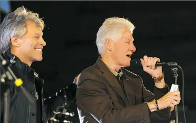  ?? Rebecca Droke/Post-Gazette ?? Jon Bon Jovi stands with former President Bill Clinton, who greets the crowd at a Get Out the Vote concert Thursday evening in support of Hillary Clinton at Soldiers and Sailors Memorial Hall in Oakland.