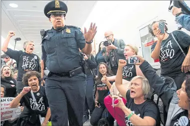  ?? SAUL LOEB — AFP/GETTY IMAGES ?? U.S. Capitol Police prepare to arrest demonstrat­ors as they protest against the nomination of Judge Brett Kavanaugh to be a Supreme Court justice outside the office of Sen. Susan Collins, R-Maine, on Monday in Washington, D.C.