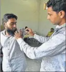  ??  ?? A poll official inks Aas Mohammed’s shoulder, his wife Irfana helps him press the EVM button.