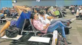  ?? AP ?? Passengers of cancelled flights wait in Hamad Internatio­nal Airport in Doha on Tuesday.