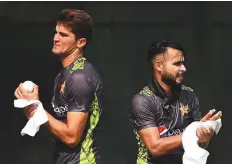  ?? AFP ?? Pakistan’s Shaheen Afridi and Faheem Ashraf go through their paces during a training session in Dubai.