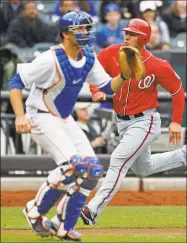  ?? Associated Press file photo ?? Josh Thole, left, agreed to a minor-league deal with the Yankees to compete for the backup catching job.