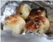  ??  ?? Jennifer Bain fell in love with the garlic knots at Full Moon Pizza, a “tried and true” institutio­n that greeter Dan Abatelli swears is “even better than the last time I remember.”