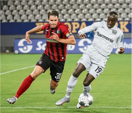  ??  ?? That’s mine: Freiburg defender Christian Guenter (left) vying for the ball with Bayer Leverkusen forward Moussa diaby during the Bundesliga match on Friday. — aFP