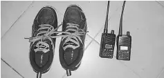  ??  ?? Two sets of walkie-talkies and the sports shoes seized by police during ‘Ops Pintu’.