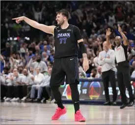  ?? TONY GUTIERREZ — THE ASSOCIATED PRESS ?? Mavericks guard Luka Doncic celebrates after sinking a 3-point basket in the second half against the Suns in Dallas on Thursday.