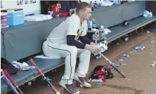  ?? AP PHOTO ?? BUMMER: Sean Newcomb sits in the dugout after losing his bid for a no-hitter on Sunday in Atlanta.