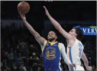  ?? SUE OGROCKI — THE ASSOCIATED PRESS ?? Warriors guard Stephen Curry (30) shoots in front of Oklahoma City Thunder guard Josh Giddey (3) in the first half of a game on Monday in Oklahoma City.