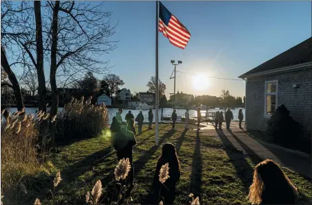  ?? DAVID GOLDMAN — THE ASSOCIATED PRESS ?? Voters line up to cast their ballots in the midterm election at the Aspray Boat House in Warwick, R.I., Nov. 8.