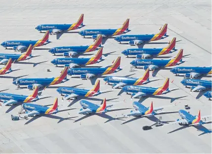  ?? Mark Ralston, AFP/Getty Images ?? Southwest Airlines’ Boeing 737 Max jets are parked on the tarmac at the Southern California Logistics Airport in Victorvill­e, Calif., after being grounded worldwide in March.