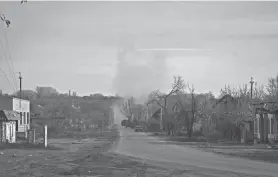  ?? ANDRIY ANDRIYENKO/AP ?? A column of Ukrainian military vehicles passes Friday by the village of Zarichne, Donetsk region, Ukraine.