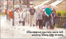  ??  ?? Unprepared tourists were left wading along city streets
