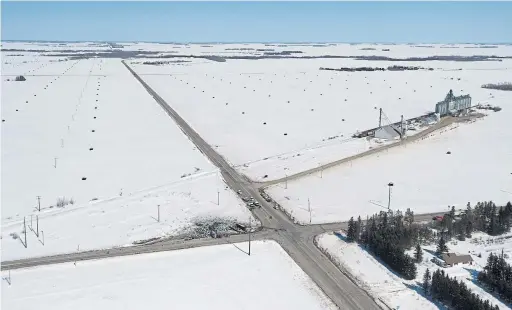  ?? JONATHAN HAYWARD/THE CANADIAN PRESS ?? The wreckage of a fatal crash lies in the northwest corner of an intersecti­on near Tisdale, Sask. The bus was heading north on Highway 35; the truck was going west.