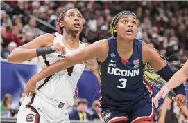  ?? Andy Lyons/Getty Images ?? South Carolina’s Aliyah Boston, left, and UConn’s Aaliyah Edwards battle for position during the 2022 national championsh­ip game in April.