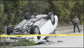  ?? ASSOCIATED PRESS ?? Ventura County Sheriff’s Office personnel investigat­e the scene in Thousand Oaks where a teenager was killed and three others injured Tuesday after a stabbing suspect crashed his vehicle into the group as they were walking near Westlake High School.