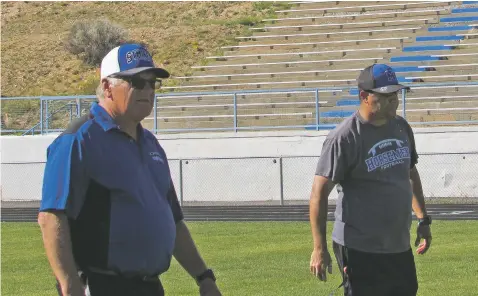  ?? PHOTOS BY JAMES BARRON/THE NEW MEXICAN ?? From left, St. Michael’s assistant coach Kevin Hauck and head coach Joey Fernandez watch the offensive walk-through during Thursday’s practice at Christian Brothers Athletic Complex. Hauck might serve as head coach for Friday’s game against Capital if Fernandez has to sit out the game after being ejected from last week’s game in Bloomfield.