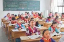  ?? Wang Jing / CHINA DAILY ?? Right: From kindergart­ens to senior middle schools, students in Tibet now enjoy 15-year free education.