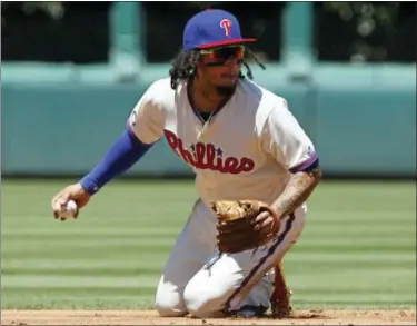  ?? TOM MIHALEK — THE ASSOCIATED PRESS ?? Philadelph­ia Phillies’ Fredy Galvis looks toward second base before completing a double play during the second inning of a baseball game against the Atlanta Braves Sunday in Philadelph­ia.