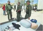  ?? PHOTOS BY NICK OZA/THE REPUBLIC ?? Top and above: Border Patrol agents discuss the dangers faced by migrants crossing the desert in summer during the Border Safety Initiative event Thursday along the U.S.-Mexico border.