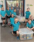  ??  ?? Delivering toys to Mark Liddy, charge nurse at the Timaru Hospital children’s ward, are from left, Josh Caird, Olivis Whitelock, Emily Collins, Zoe Dupont, Alice Dale, Greta Dale, Lucy Jarvis, Quilian Bielski and Emmerson Ward.