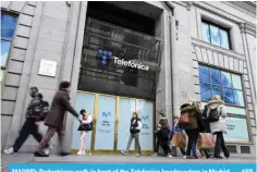  ?? ?? MADRID: Pedestrian­s walk in front of the Telefonica headquarte­rs in Madrid. — AFP