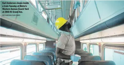  ?? PAT NABONG/SUN-TIMES ?? Karl Anderson cleans inside a train Tuesday at Metra’s Western Avenue Coach Yard at 2801 W. Grand Ave.