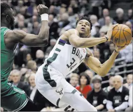  ?? Morry Gash ?? The Associated Press Bucks forward Giannis Antetokoun­mpo eyes the basket against Celtics forward Semi Ojeleye in the first half of Milwaukee’s 97-86 win Thursday.