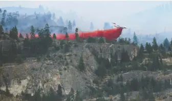  ?? B.C. WILDFIRE SERVICE ?? Fire retardant is dropped on the Christie Mountain fire last week.