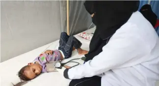  ??  ?? A nurse attends to a boy infected with cholera at a hospital in Hodeidah, Yemen. (Reuters)