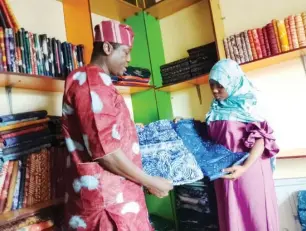  ?? ?? A trader, Ogunfidodo Michael attending to customer at Itoku Adire/Kampala market in Abeokuta, Ogun State