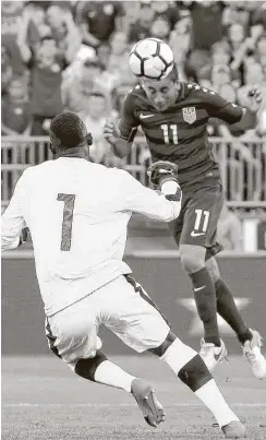  ?? Jim Rogash / Getty Images) ?? U.S. national team midfielder Alejandro Bedoya directs a header against goalkeeper Richard Ofori of Ghana during an internatio­nal friendly July 1 in East Hartford, Conn., which the U.S. won 2-1.