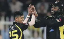  ??  ?? Sandeep Lamichhane celebrates the fall of Mohammed Kaleem with his Kerala Knights teammate Chris Gayle