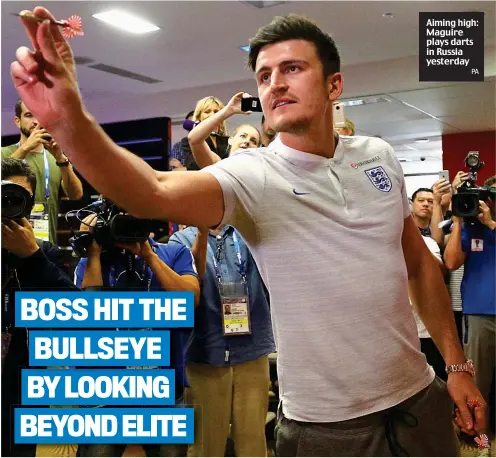  ?? PA ?? Aiming high: Maguire plays darts in Russia yesterday