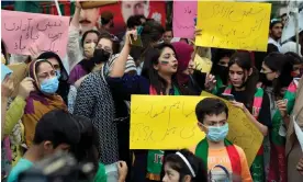  ?? Photograph: KM Chaudary/AP ?? Supporters of Imran Khan hold placards that read ‘Save Pakistan, save the constituti­on’ during a protest outside his house in Lahore.