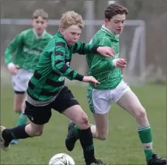  ??  ?? Tomás Mythen (Gorey Celtic) powers past Aodhán Collins (Forth Celtic).