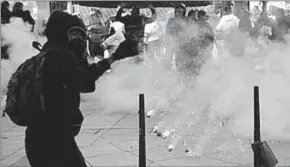  ??  ?? A hooded youth kicks a tear gas canister during clashes at a demonstrat­ion to protest the results of the first round of the presidenti­al election in Paris, France.(Photo: Reuters.com)