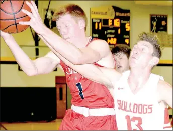  ?? RICK PECK/SPECIAL TO MCDONALD COUNTY PRESS ?? McDonald County’s Blake Gravette takes a rebound away form Carl Junction’s Will Bebee during the Mustangs’ 59-41 loss on March 1 in the district semifinals at Cassville High School.