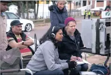  ??  ?? IT’S A WRAP: Director Jayan Moodley and script supervisor Ashley Aldworth focus on the monitor during the filming of Keeping up with the Kandasamys in Chatsworth, Durban, as producers Junaid Ahmed, left, and Helena Spring, back, look on.