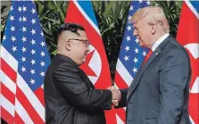  ?? EVAN VUCCI THE ASSOCIATED PRESS ?? U.S. President Donald Trump shakes hands with North Korea leader Kim Jong Un Tuesday.